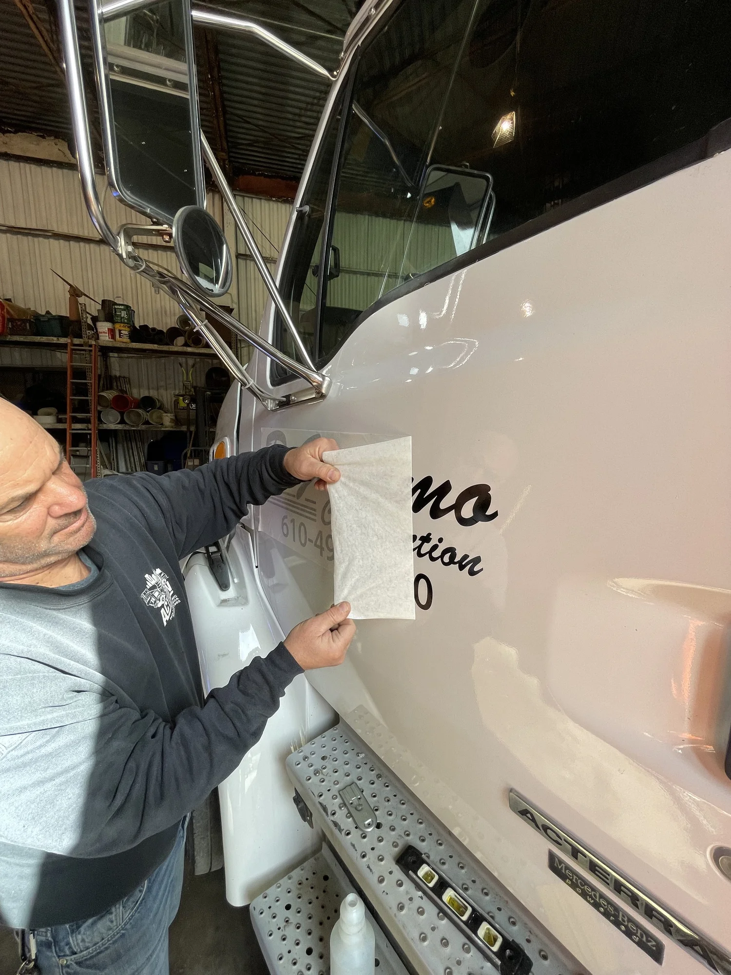 Jerry DiGiacomo lettering the company truck